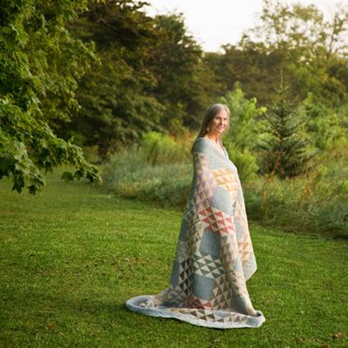 AnnMarie Rowland wrapped in one of her quilts.