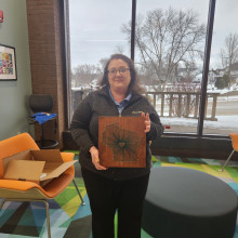 An artisan with their string art project.