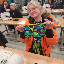 An artisan with her sewn bag project.