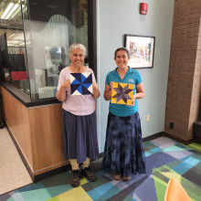 Two artisans with their barn quilt projects.